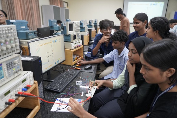 Students exploring circuit connections and laboratory equipment